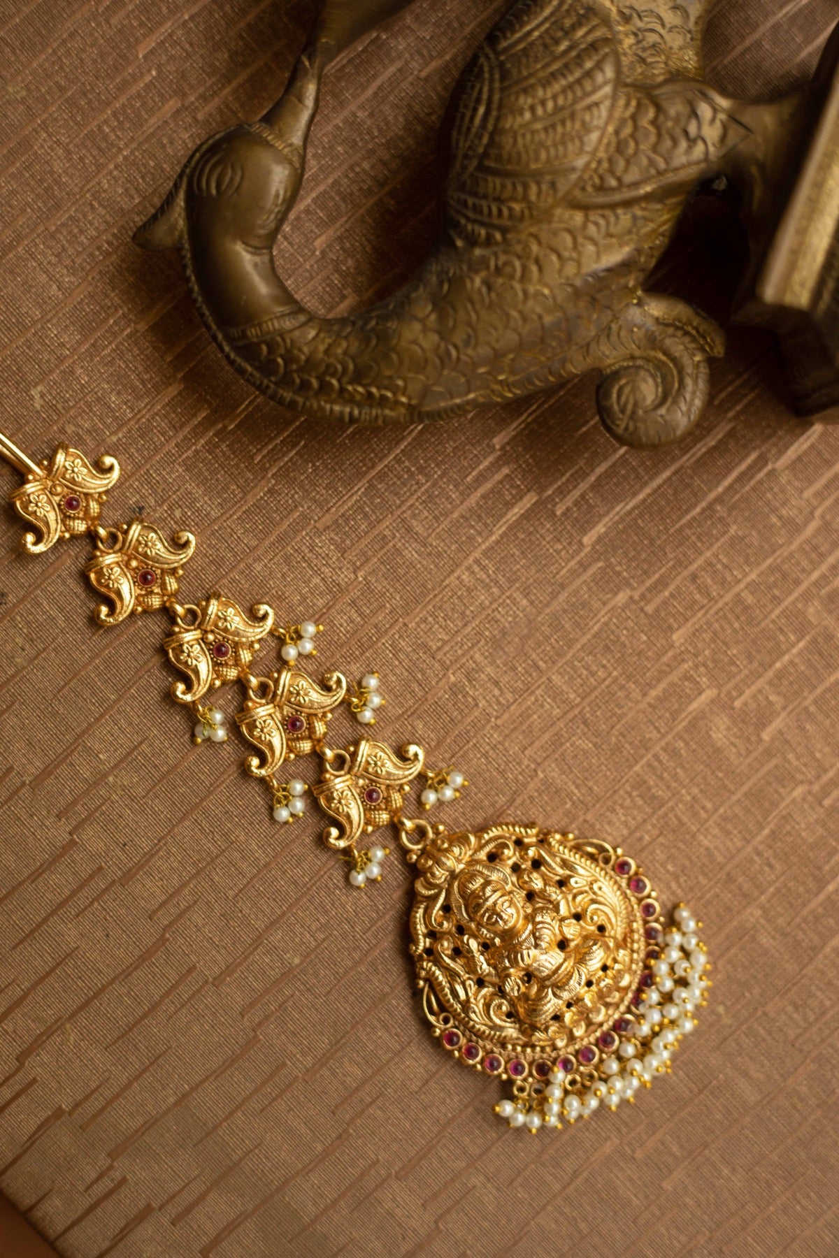 Gold Finish Nagasu Tikka mango motifs model with Lakshmi Carving Nagasu -Ruby
