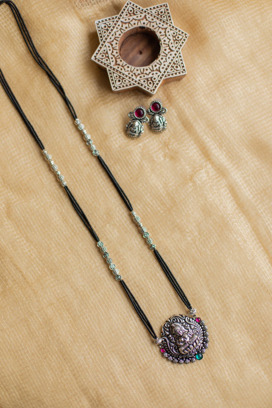 5 layered black beads with lakshmi pendant