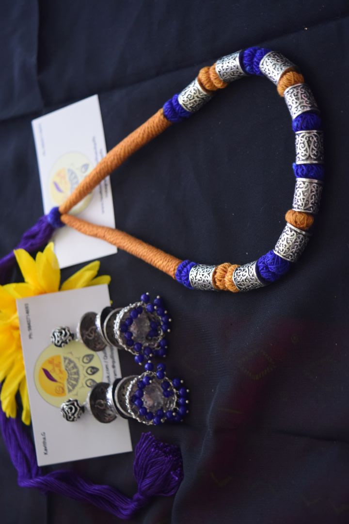 Yellow and violet thread with cylindrical beads.