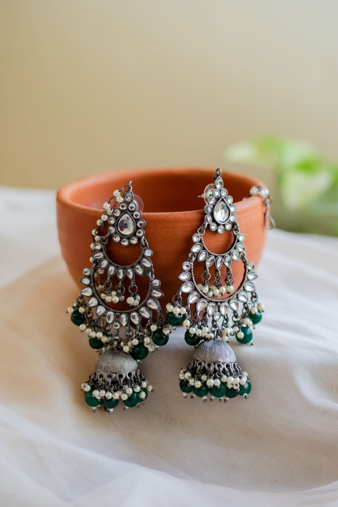 German Silver finish tear drop kundan layered stud jhumkas with maatal & Green Beads